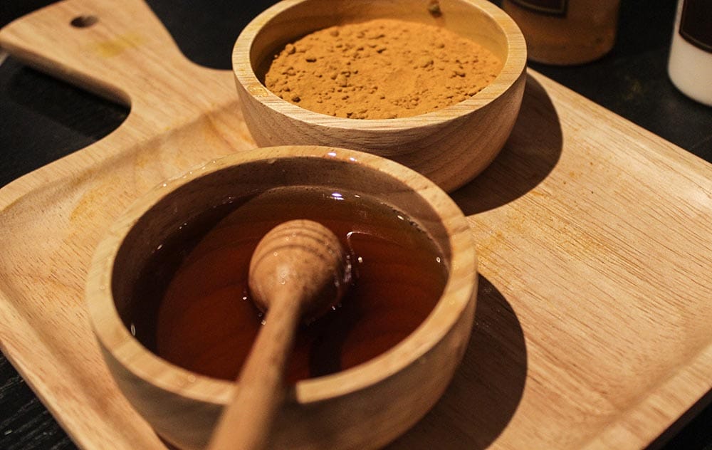 Wooden bowls with honey and tumeric