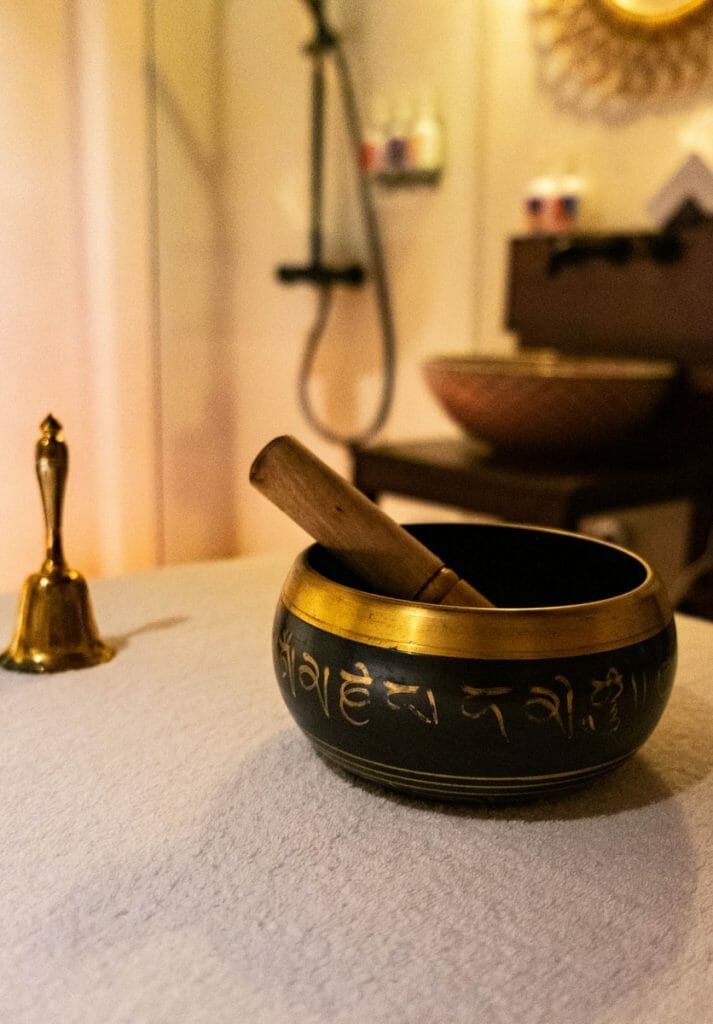 Singing bowl and bell on a massage table