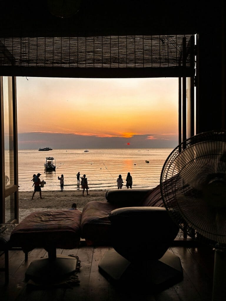 massage chair by the ocean at sunset