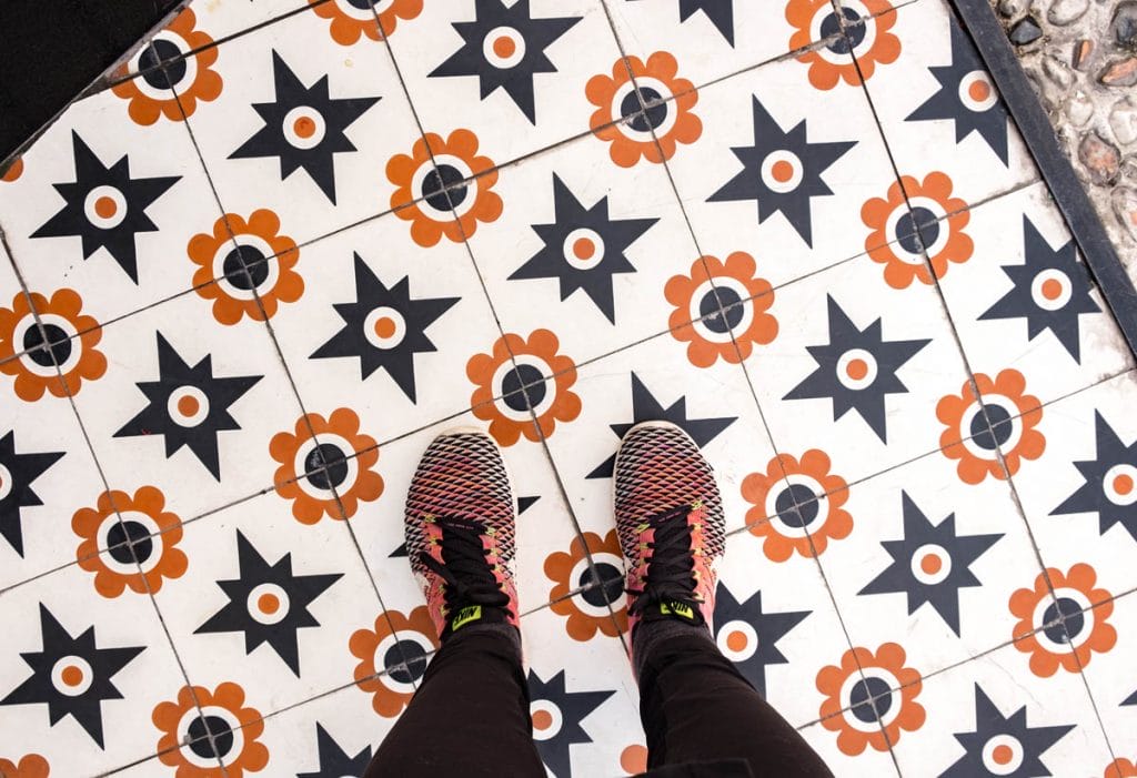 Feet in Nike sneakers on a tiled floor in Istanbul