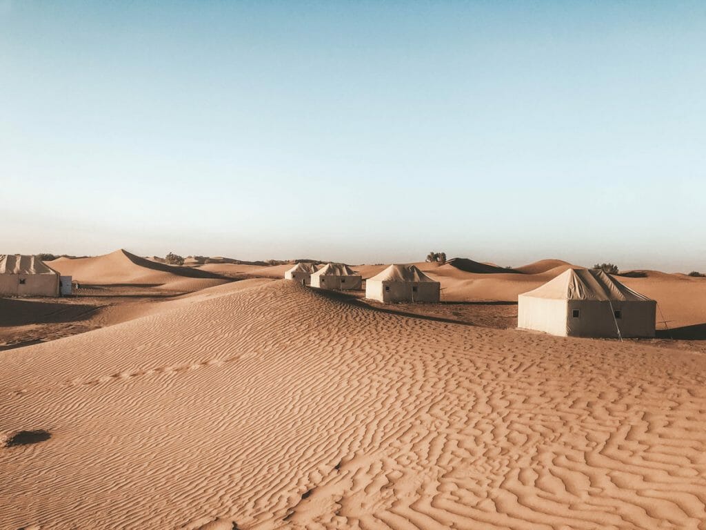 White tents in sand dunes in the desert