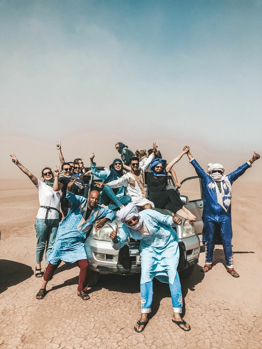Group of travelers on a jeep in the Sahara