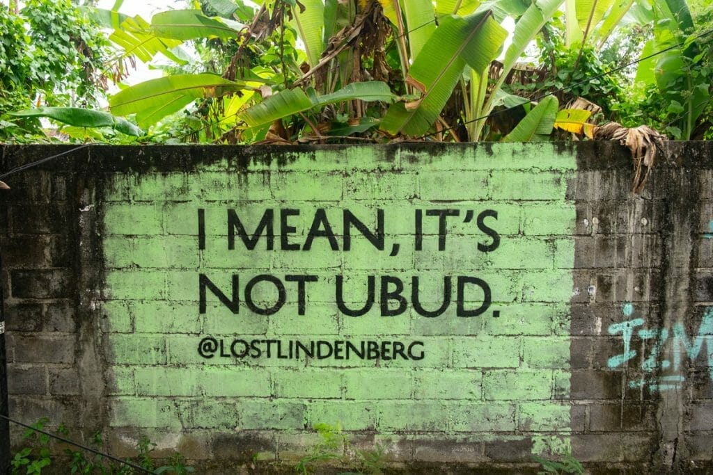 Green sign about Ubud on a wall in Canggu