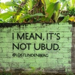 Green sign about Ubud on a wall in Canggu