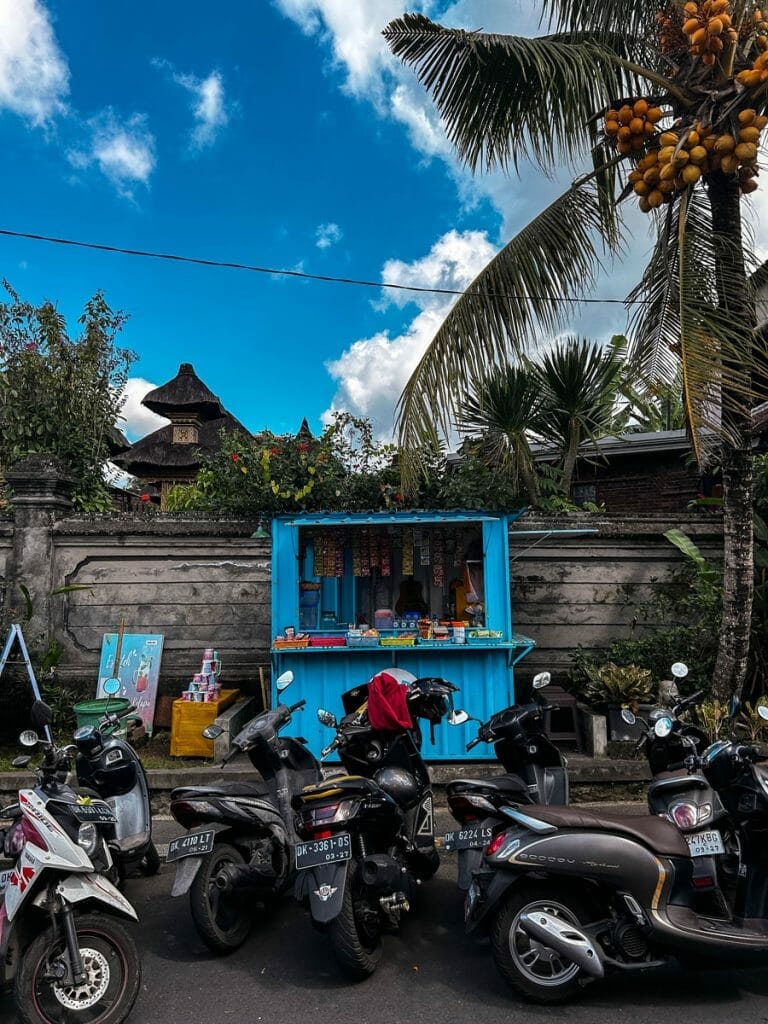 Blue kiosk and motorbikes in Ubud