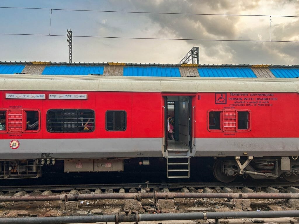 Red train with open door in India