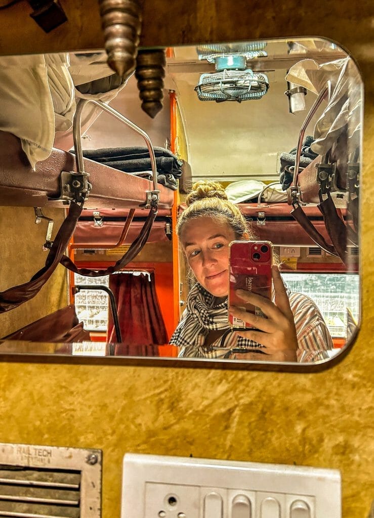 Annika Ziehen taking a mirror selfie on a train in India